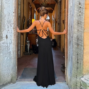 Close-up of the elegant open-back design with metal rings on this black maxi dress