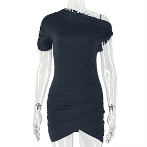 Close-up of the asymmetric shoulder and ruched hem detail on the black bodycon dress