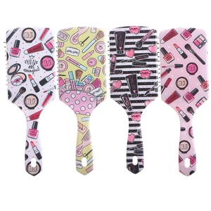 Detailed view of four cushion hair brushes with vibrant cosmetic-themed floral prints