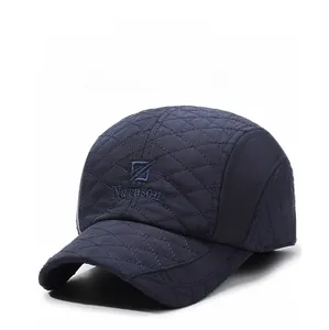 Detail view of navy blue ear-flap baseball cap with quilted pattern and Narason embroidery