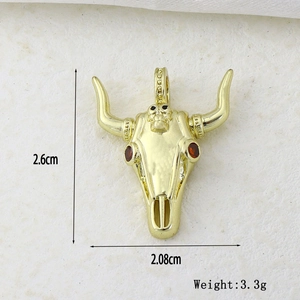 Detailed view of golden bull skull pendant with dimensions 2.6cm x 2.08cm and 3.3g weight