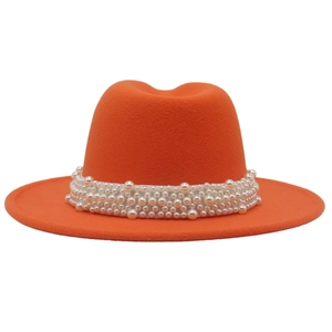 Detailed view of the orange fedora hat featuring a wide brim and premium pearl trim