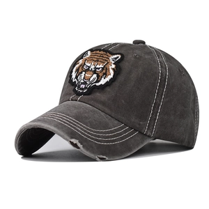 Detailed view of tiger head embroidery and distressed washed cotton on a baseball cap