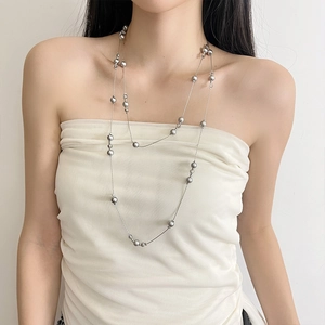 Elegant multi-layered gray pearl long necklace with metallic luster on white background