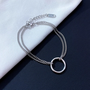 Minimalist double-layer silver stainless steel bracelet featuring a circular ring charm