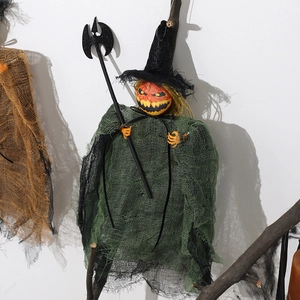 Hanging Halloween pumpkin witch decoration with green mesh cloak and black axe prop