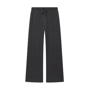 Detailed view of black wide-leg knit trousers featuring an adjustable drawstring waistband