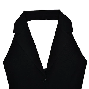 Close-up detail of the black V-neck halter dress featuring a lapel collar and single button