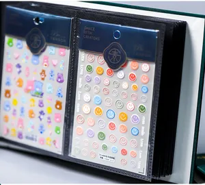 Close-up of macaron smiley and bear stickers inside a black loose-leaf storage album