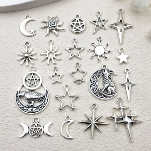Detailed flat lay of silver alloy celestial charms including sun moon and stars for DIY