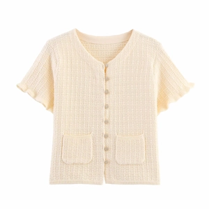 Detail of cream knit cardigan with crochet texture, ruffle sleeves and pearl buttons