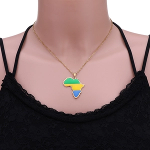 Detailed view of an African map pendant necklace with green yellow and blue enamel on gold chain