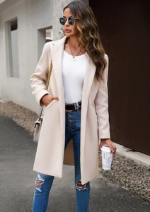 Street style shot of a beige long wool coat with lapels and pockets for women