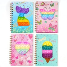 Detailed view of four colorful macaron silicone pop-it notebook covers with spiral binding