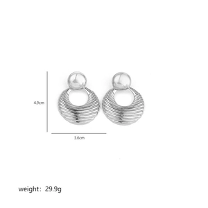Detail showing oversized silver irregular metal earrings with dimensions 4.9cm by 3.6cm