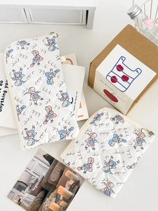 Detailed view of quilted cotton storage bags with cute cartoon prints and zipper closure