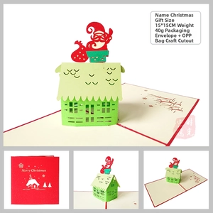 Detailed 3D pop-up Christmas card featuring hollow out Santa and green house with envelope