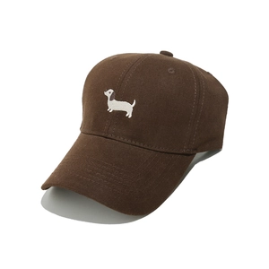 Detail of dachshund embroidery on brown cotton baseball cap with ventilation eyelets