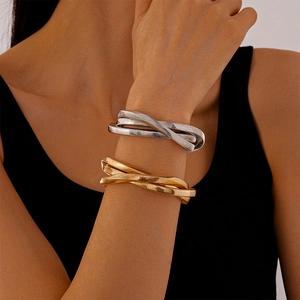 Stacked metallic twist bangles in gold and silver finish with wavy textured design
