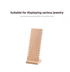 Close-up of natural wood necklace display stand with side notches for jewelry storage