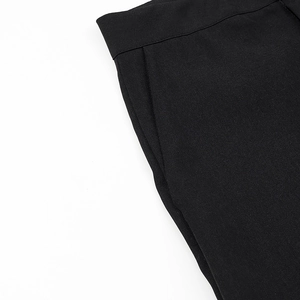 Detailed close-up of high-quality twill fabric and stitching on black high waist trousers