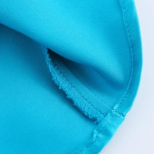 Detail view showing blue satin fabric texture and neat stitching of the elegant dress
