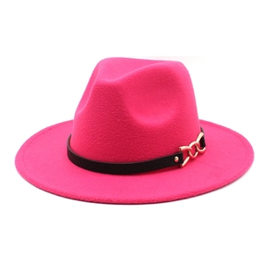 Detail of rose pink wool fedora with black textured band and gold chain accent