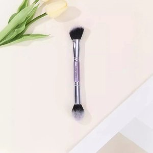 Dual-ended purple makeup brush with powder and angled contour bristles on beige background