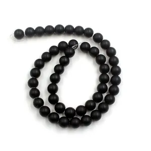 Macro shot of matte black round beads with a frosted texture for DIY jewelry making