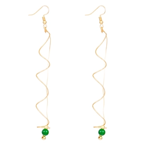 Detailed view of long gold spiral wire earrings featuring green beads and wave design