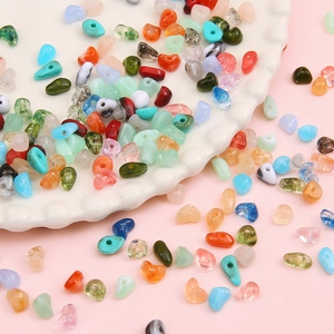 Colorful irregular acrylic beads for DIY jewelry making in a white ceramic dish
