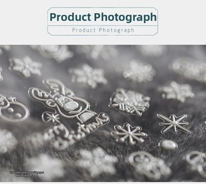 Macro shot of 3D embossed Christmas nail stickers featuring white reindeer and snowflakes