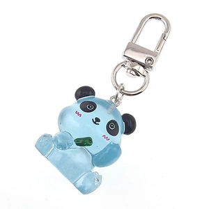 Macro shot of a blue translucent resin panda keychain with silver metal swivel hook and ring