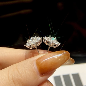 Sparkling moissanite flower stud earrings in silver prong setting with brilliant starburst shine