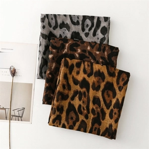 Three leopard print scarves in gold, coffee, and grey displayed on a white background
