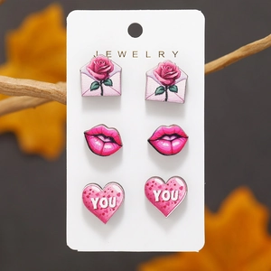 Set of three wooden stud earrings featuring pink hearts, lips, and rose envelope designs