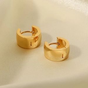 Minimalist wide 18K gold-plated stainless steel hoop earrings on silk background