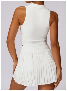 Detail of white tennis set showing racerback vest and pleated skirt from the back view