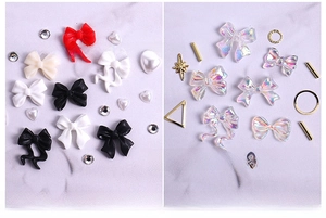 Detail of aurora resin bows and pearl heart nail art charms with gold alloy accents