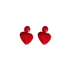 Polished red heart pendant earrings with minimalist style on a white background