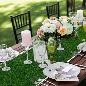 Outdoor wooden table set with realistic artificial grass runner for wedding decoration