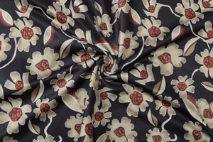 Close-up of floral print on black fabric featuring beige flowers and brown stamen detail