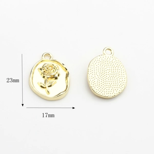 Detailed view of gold-tone oval rose pendants with 23mm height and 17mm width specs