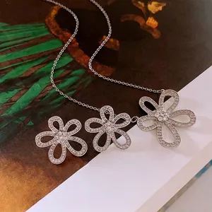 Élégant collier en argent s925 avec trois fleurs en zircone sur fond de livre d'art