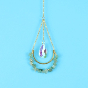 Detail of crescent moon suncatcher with green beads and teardrop rainbow crystal