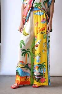 Detail of high-waisted wide-leg trousers featuring colorful tropical floral prints