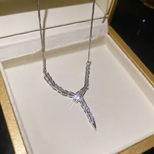 Sparkling silver snake-shaped necklace with micro zircons on a white velvet display