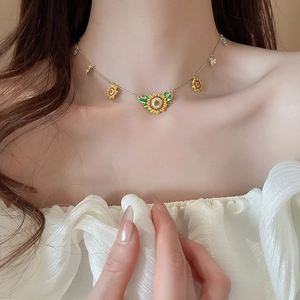 Detailed view of sunflower and bee pendant necklace with colorful oil dripping technique