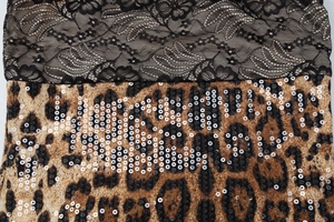 Detail showing lace stitching and leopard print fabric with silver sequins on the dress