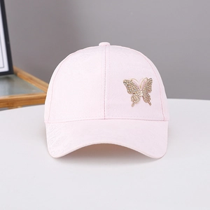 Close-up of pink baseball cap featuring rhinestone butterfly and floral jacquard texture